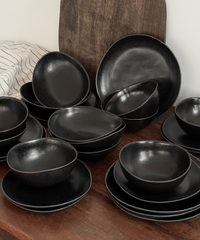 Handmade black ceramic tableware set in organic shape