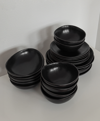 Handmade black ceramic tableware set in organic shape
