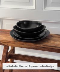 Handmade black ceramic tableware set in organic shape