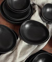 Handmade black ceramic tableware set in organic shape