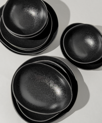 Handmade black ceramic tableware set in organic shape