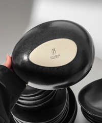 Handmade black ceramic tableware set in organic shape